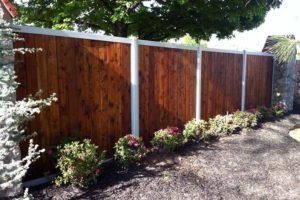 Stained Wood Fence With Metal Posts